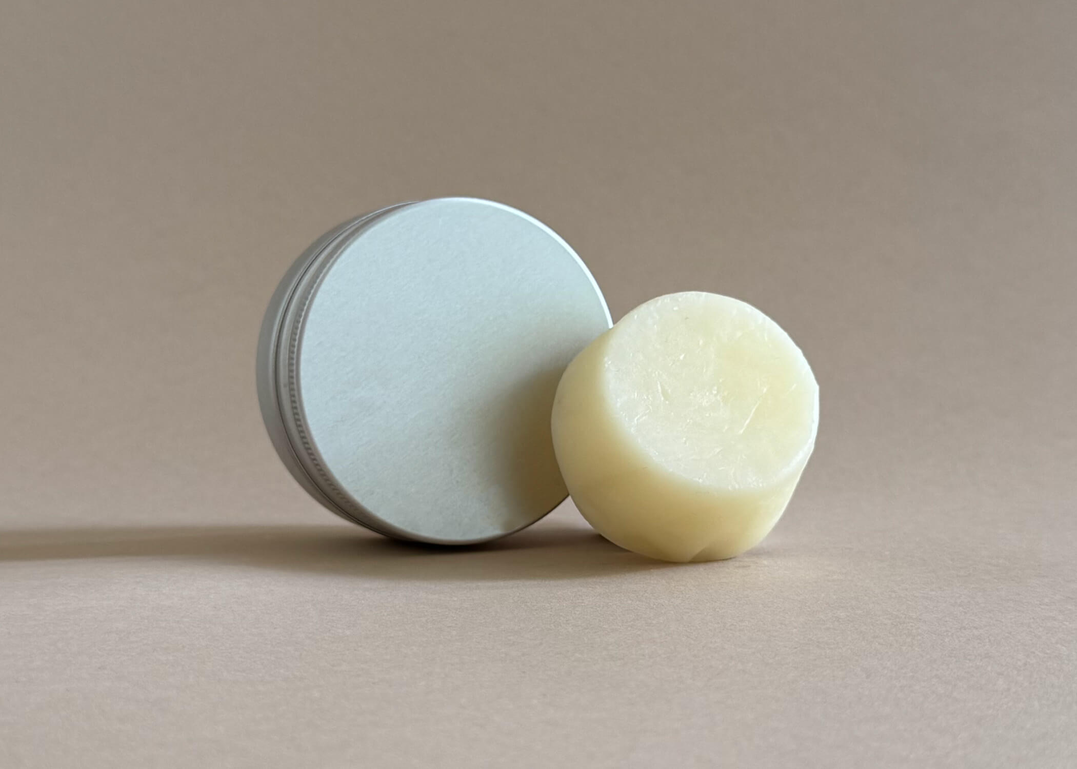 Eco-friendly conditioner bar for curly or fine hair, styled with natural elements, organic and ideal for travel