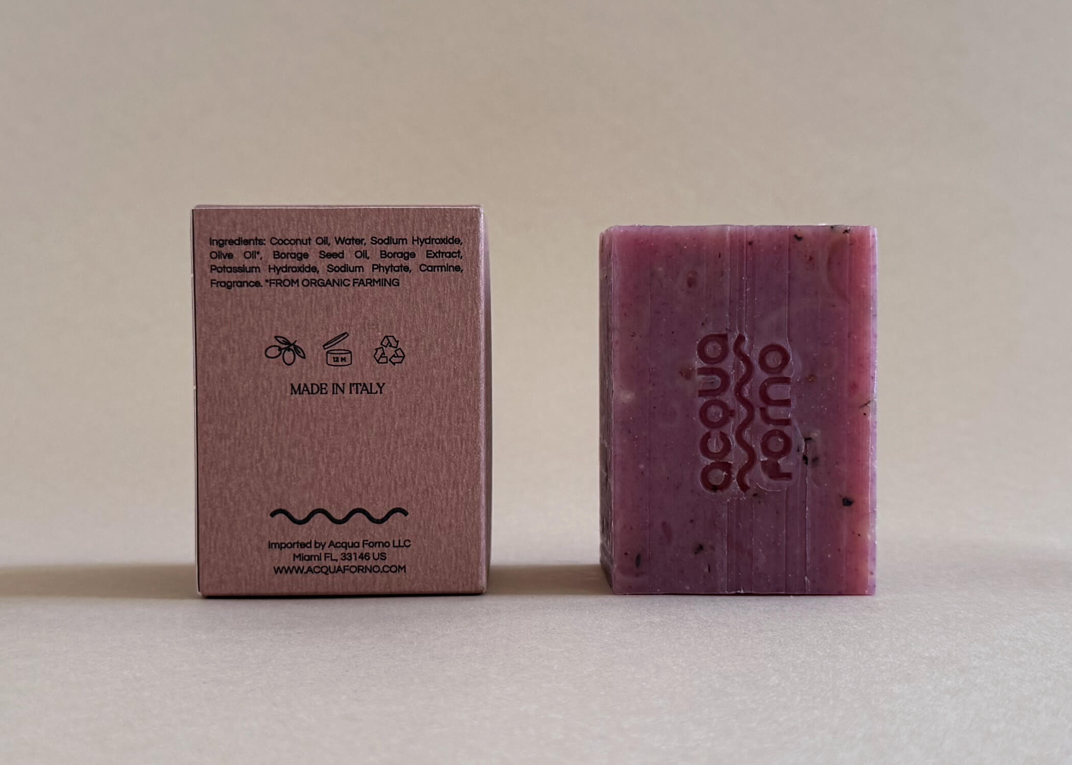 Artisan soap bar styled on marble with botanicals, handmade in Italy with borage, olive oil, and blackberry extract