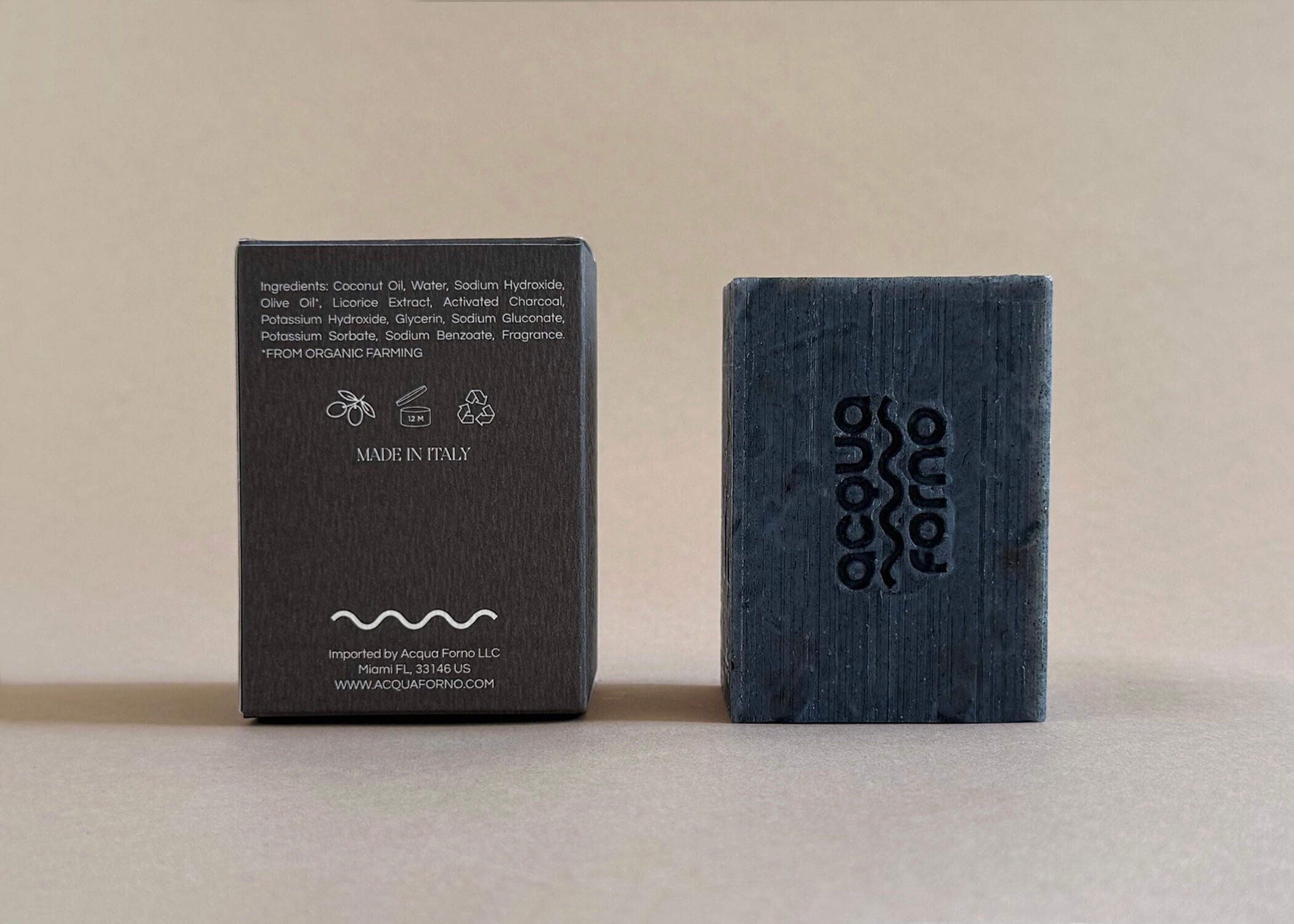 Charcoal and licorice detox soap bar placed on a stone surface, handcrafted in Italy, 150g natural skincare product